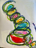 Abstract pastel and crayon drawing on white paper featuring layered spiral and oval shapes in green, blue, pink, yellow, and red.